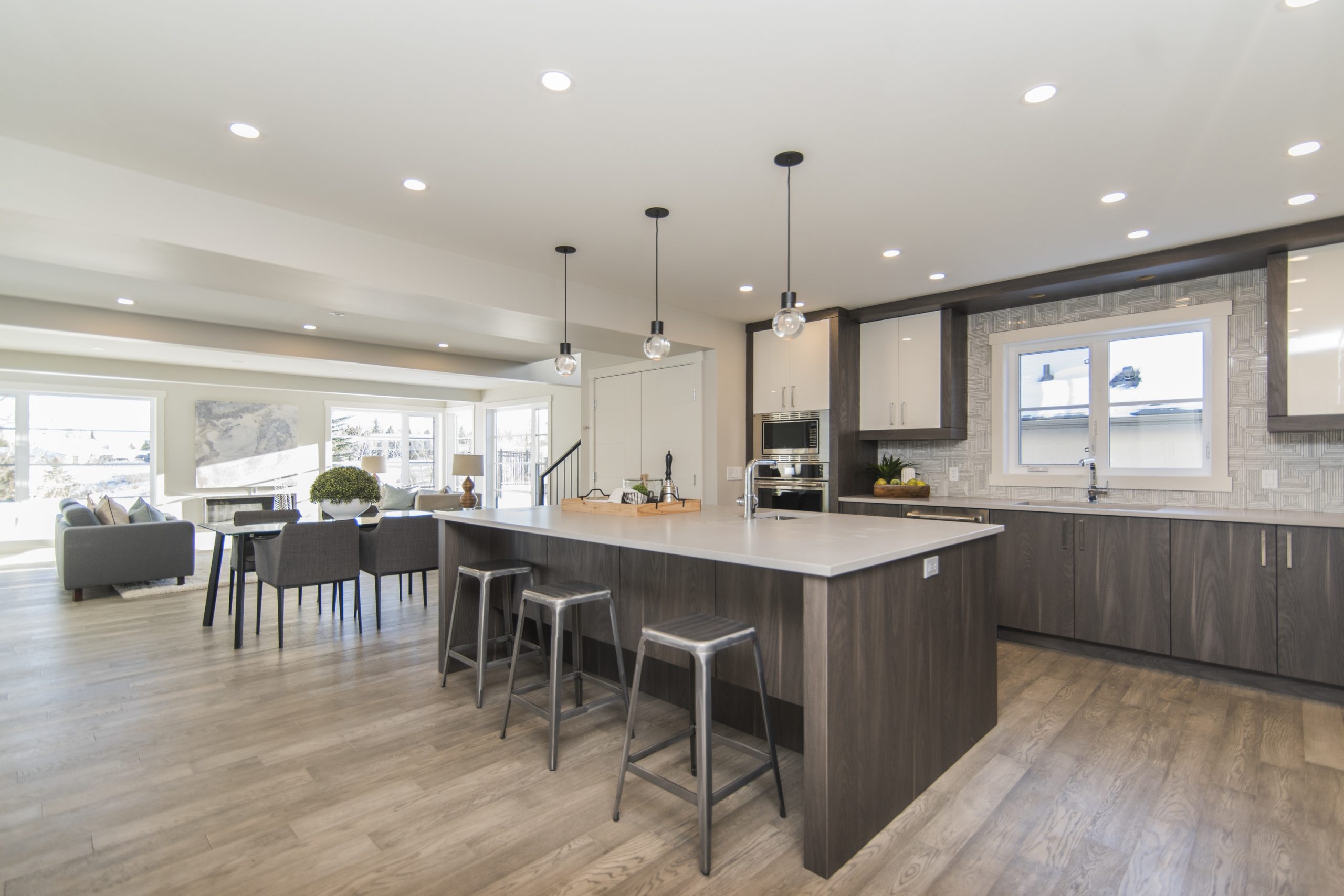 A kitchen with warm colored floors and cabinetry that underwent kitchen remodeling services.